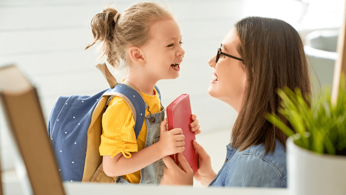 Mother and child smiling before school, representing co-parenting routine in Denton, TX